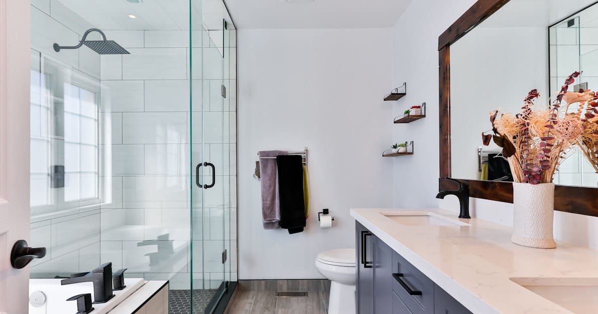Bathroom with a toilet beside a shower and vanity sink