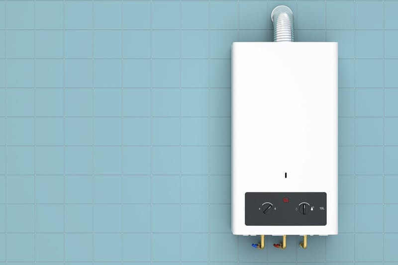 Wall-mounted tankless water heater on a tiled wall