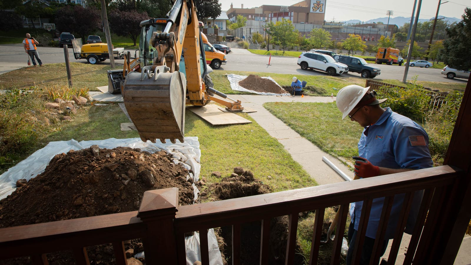 New copper water line being pulled through a bored underground path at a residential property